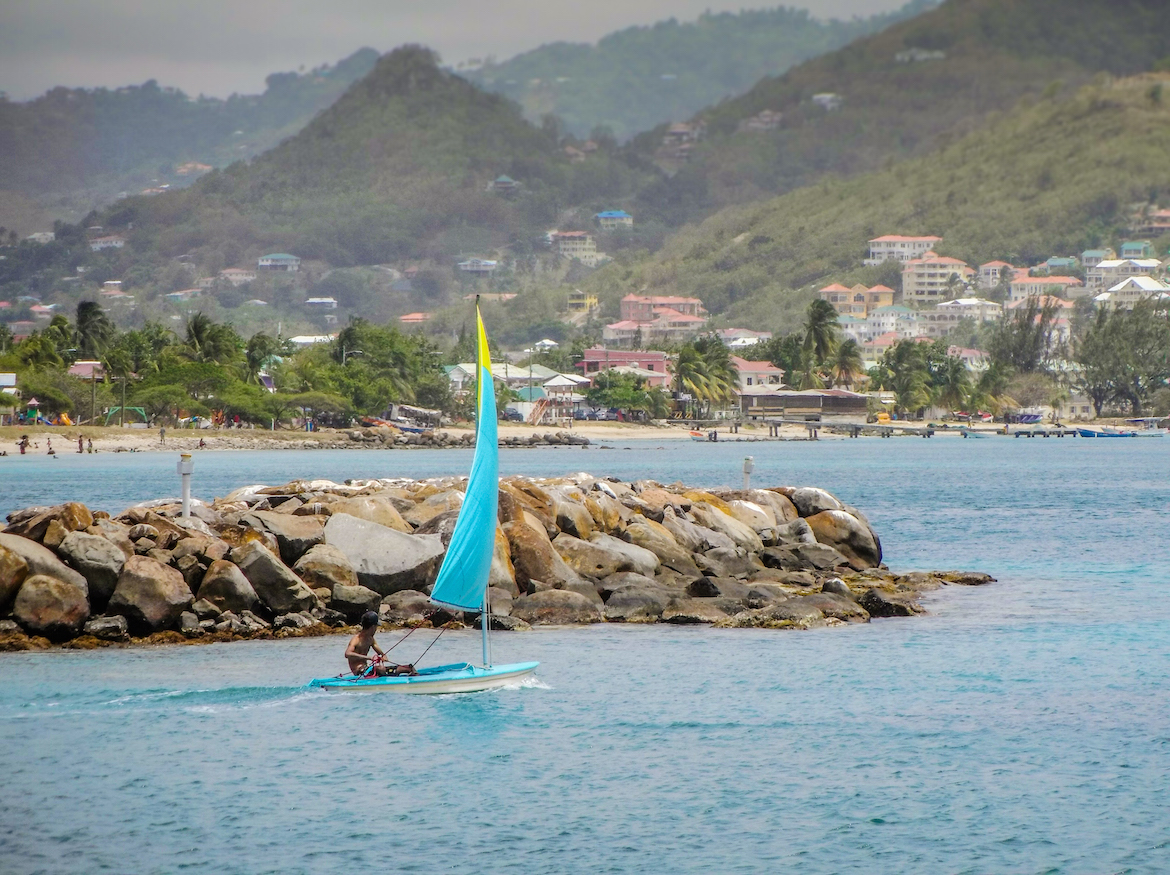 A man sails a boat in Rodney Bay, St Lucia