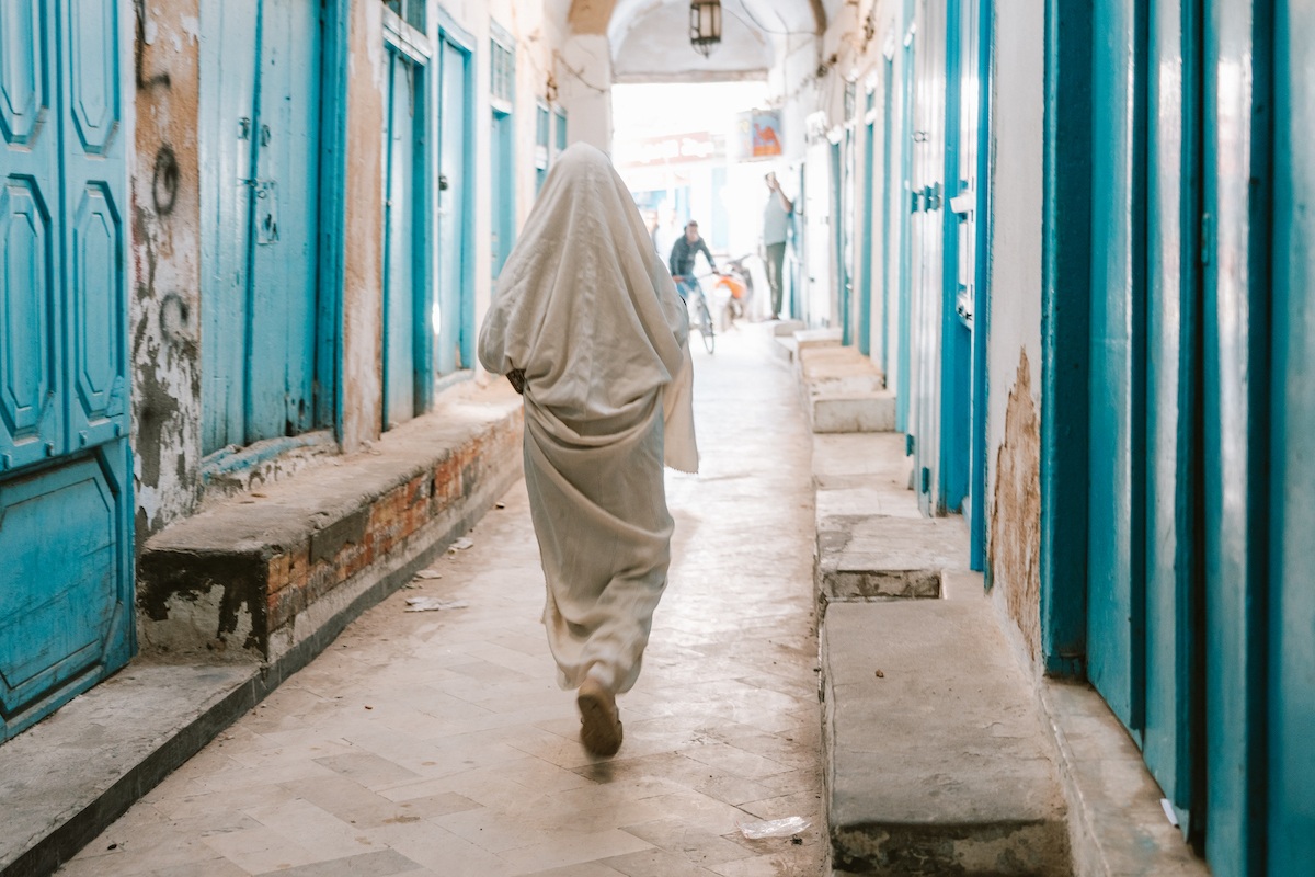 A woman walking through the medina in Kairouan